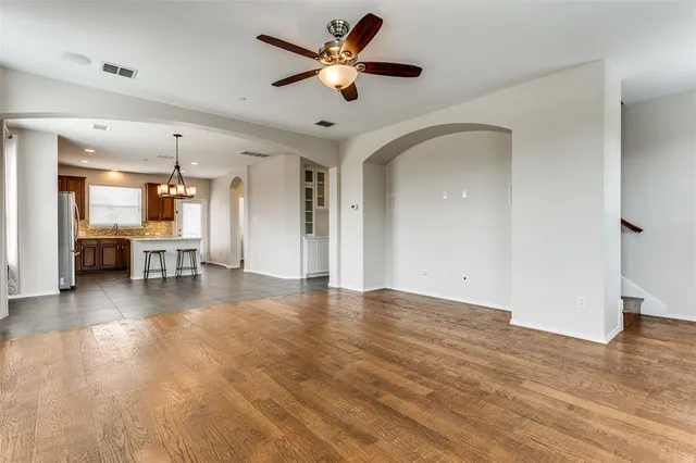 a view of a livingroom with a hardwood floor and a ceiling fan