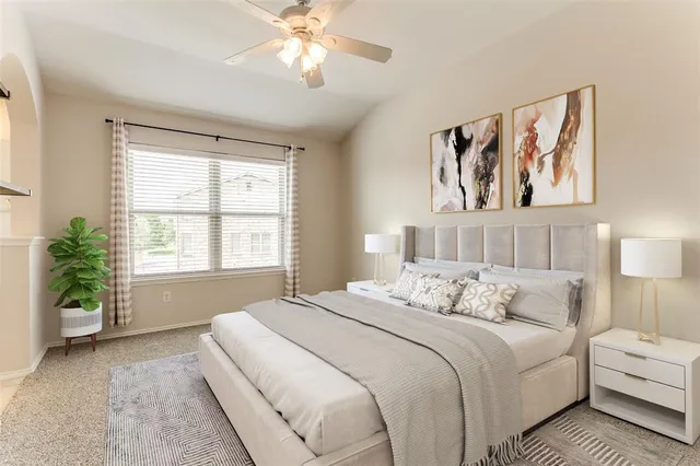 a bedroom with a large bed and a chandelier