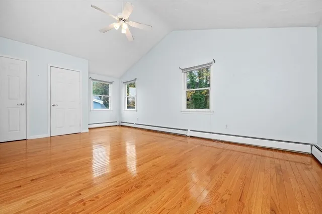 an empty room with window and wooden floor