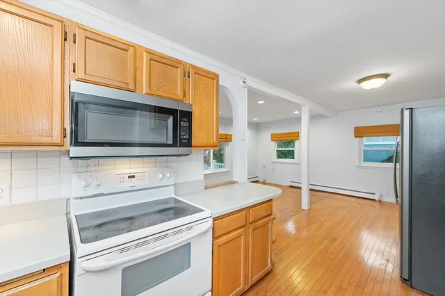a kitchen with granite countertop a stove and a microwave