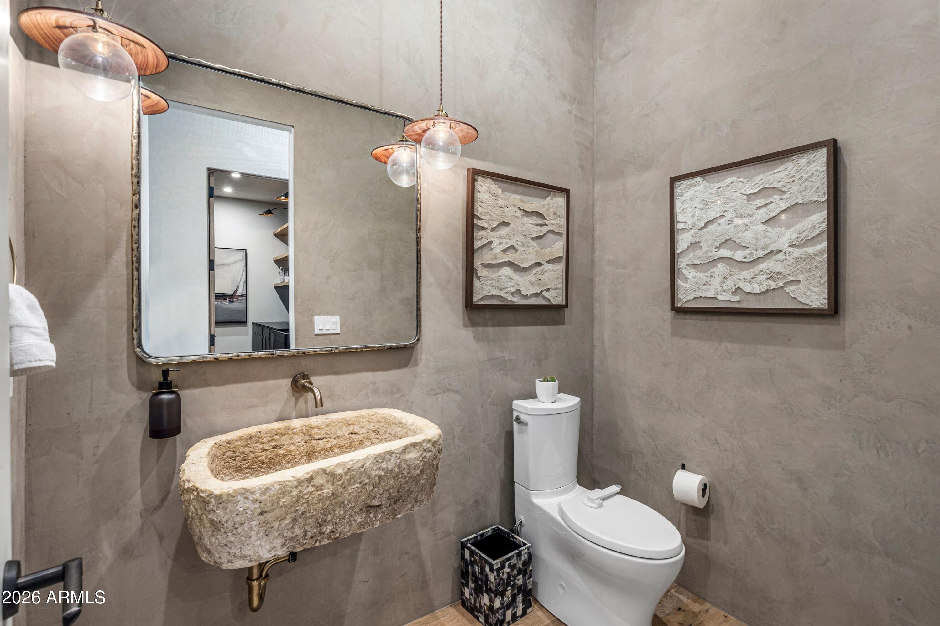 8307 East Gary Road Scottsdale, AZ 85260 - Photo 24 of 34 a bathroom with a granite countertop sink mirror vanity and toilet