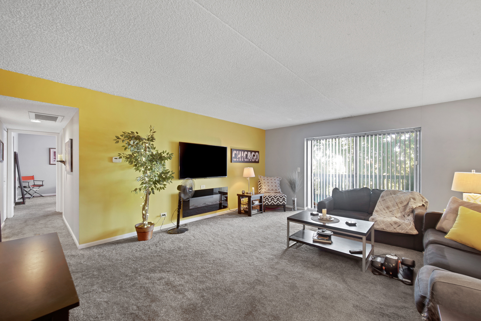 690 Chandler Road, Unit 302 Gurnee, IL 60031 - Photo 12 of 51 a living room with furniture and a flat screen tv