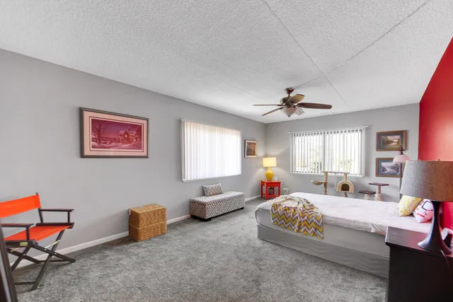 a bedroom with furniture a bed and a chandelier