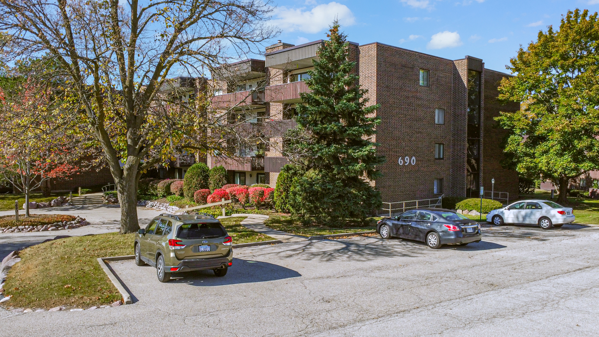 690 Chandler Road, Unit 302 Gurnee, IL 60031 - Photo 47 of 51 a car parked in front of a building