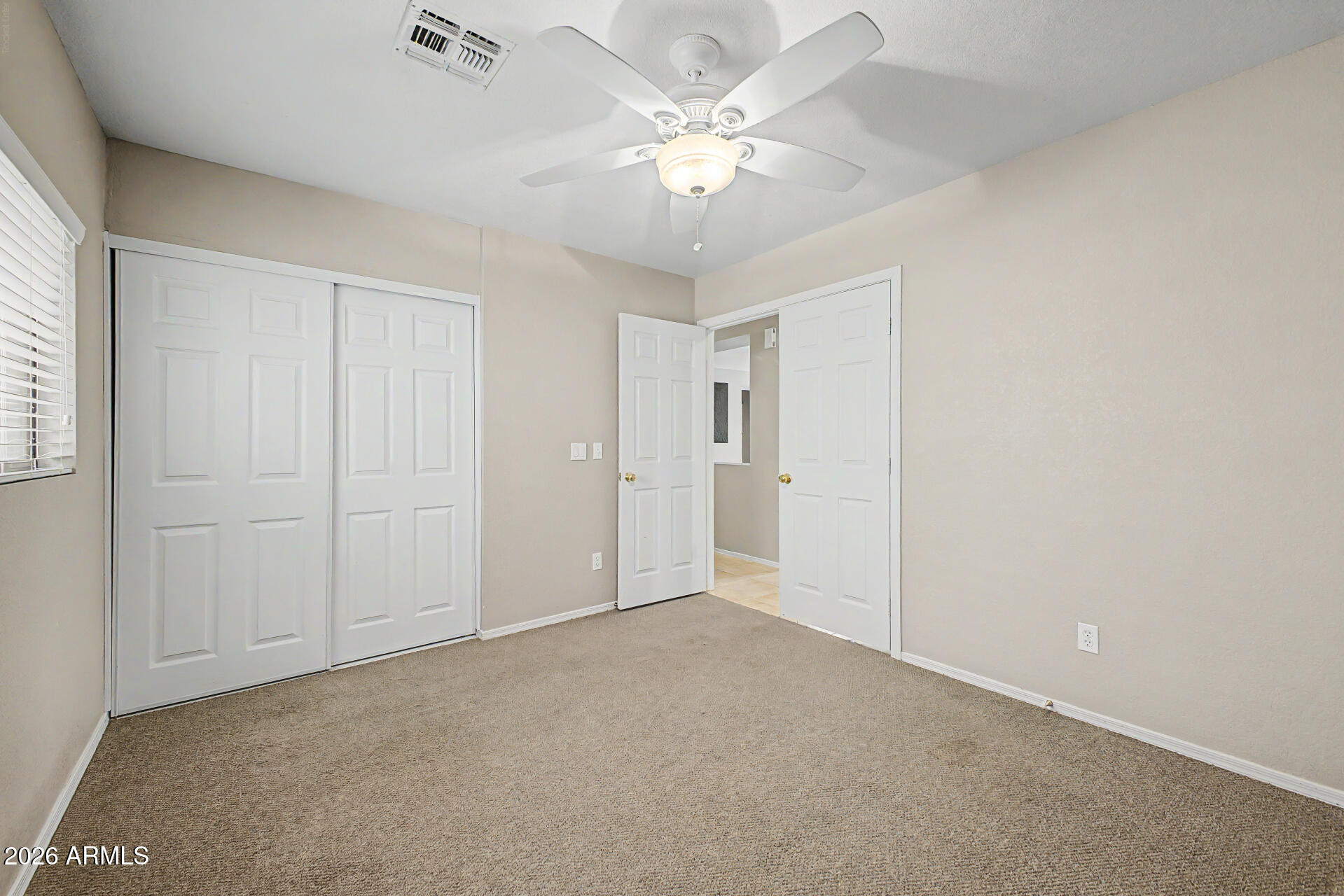 3489 South Bowman Road Apache Junction, AZ 85119 - Photo 6 of 24 a view of an empty room with a chandelier fan
