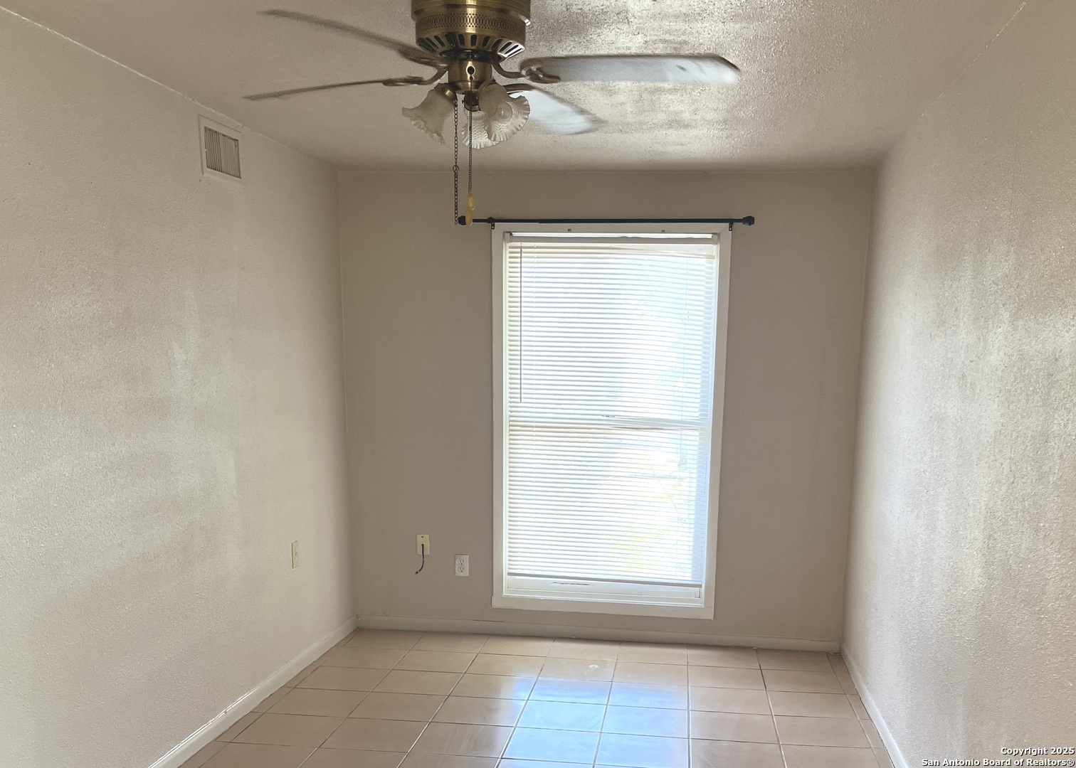 222 Audrey Alene Drive, Unit 2 San Antonio, TX 78216 - Photo 7 of 11 an empty room with a window and a fan