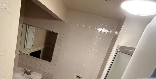 a view of a wooden deck and a backyard