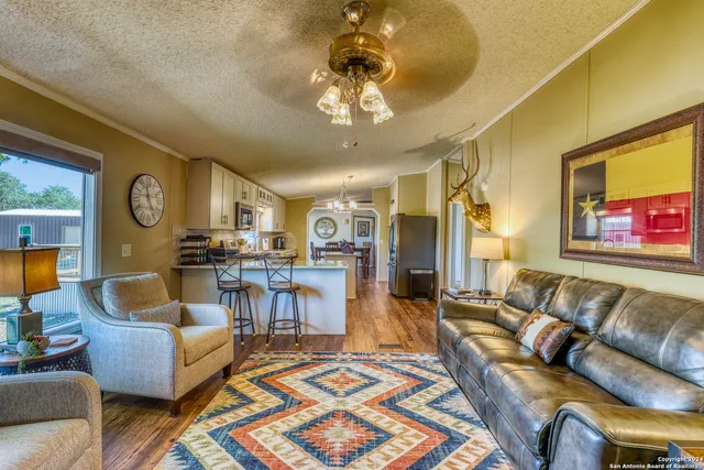 a living room with furniture and a chandelier