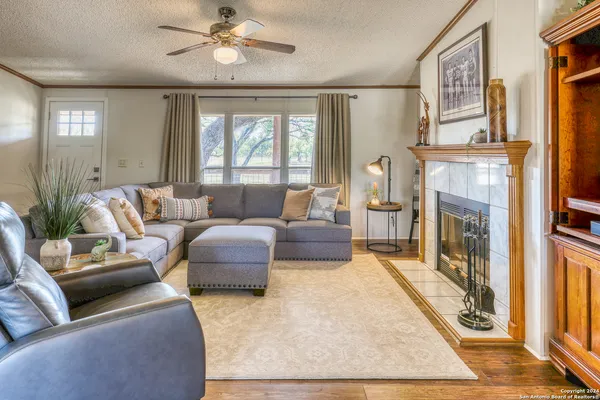 a living room with furniture and a fireplace