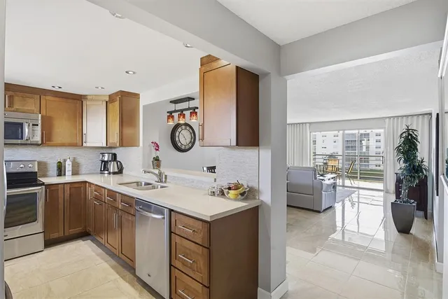 a kitchen with a sink stove and refrigerator