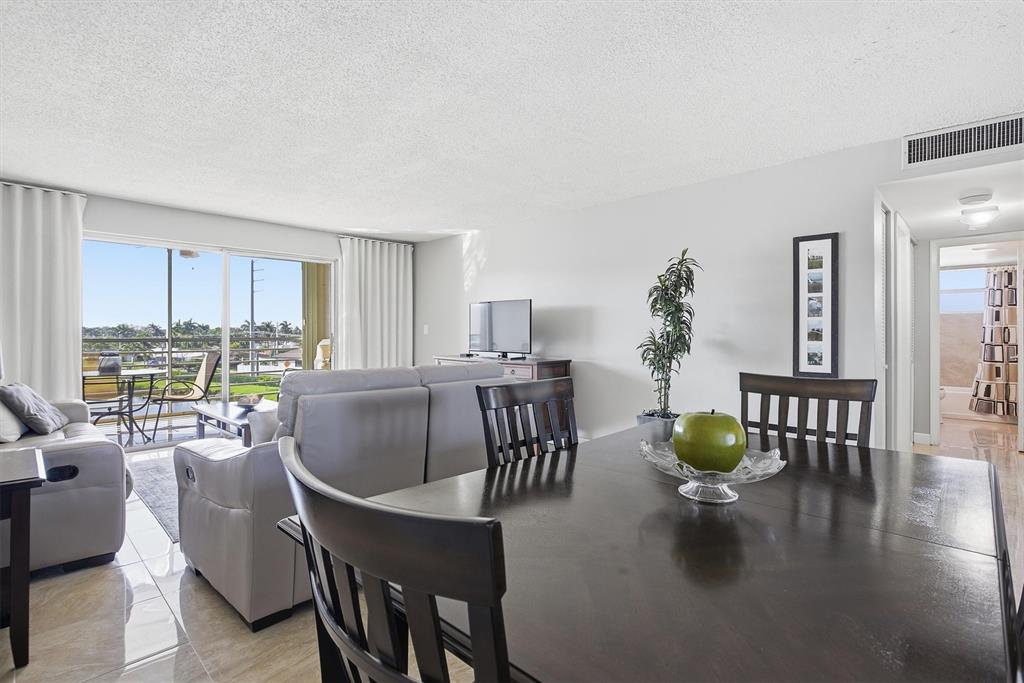 311 Southeast 3rd Street, Unit 410 Dania Beach, FL 33004 - Photo 11 of 51 a dining room with furniture and wooden floor