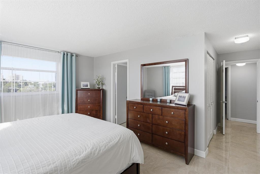 311 Southeast 3rd Street, Unit 410 Dania Beach, FL 33004 - Photo 19 of 51 a bedroom with a bed and a dresser