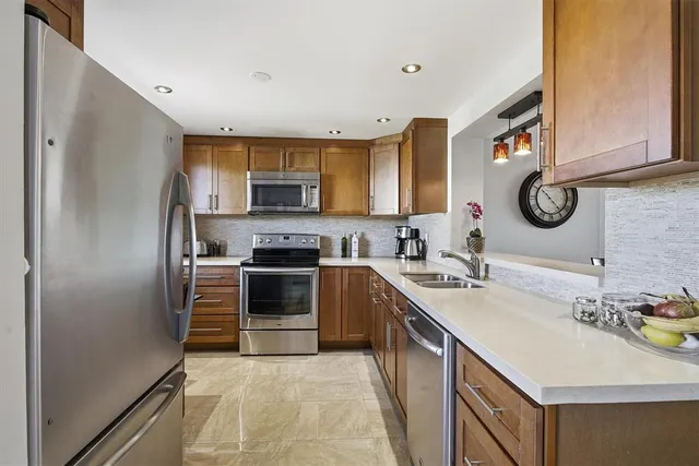 a kitchen with a sink stove and refrigerator