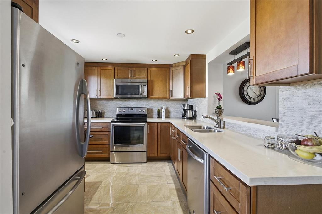 311 Southeast 3rd Street, Unit 410 Dania Beach, FL 33004 - Photo 2 of 51 a kitchen with a sink stove and refrigerator