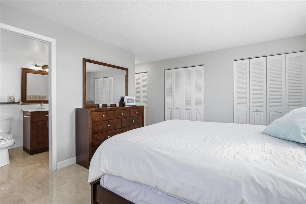 311 Southeast 3rd Street, Unit 410 Dania Beach, FL 33004 - Photo 21 of 51 a bedroom with a bed and a dresser