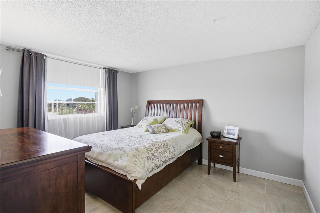 311 Southeast 3rd Street, Unit 410 Dania Beach, FL 33004 - Photo 24 of 51 a bedroom with a bed and a window
