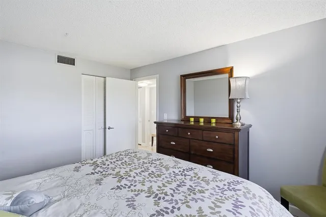 a bedroom with a bed and a mirror