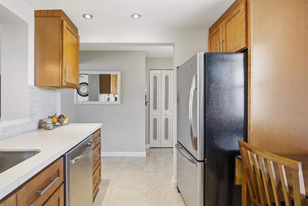 311 Southeast 3rd Street, Unit 410 Dania Beach, FL 33004 - Photo 4 of 51 a kitchen with a refrigerator and a sink