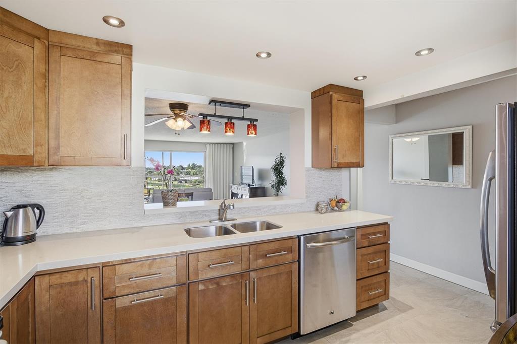 311 Southeast 3rd Street, Unit 410 Dania Beach, FL 33004 - Photo 5 of 51 a bathroom with a sink and a mirror