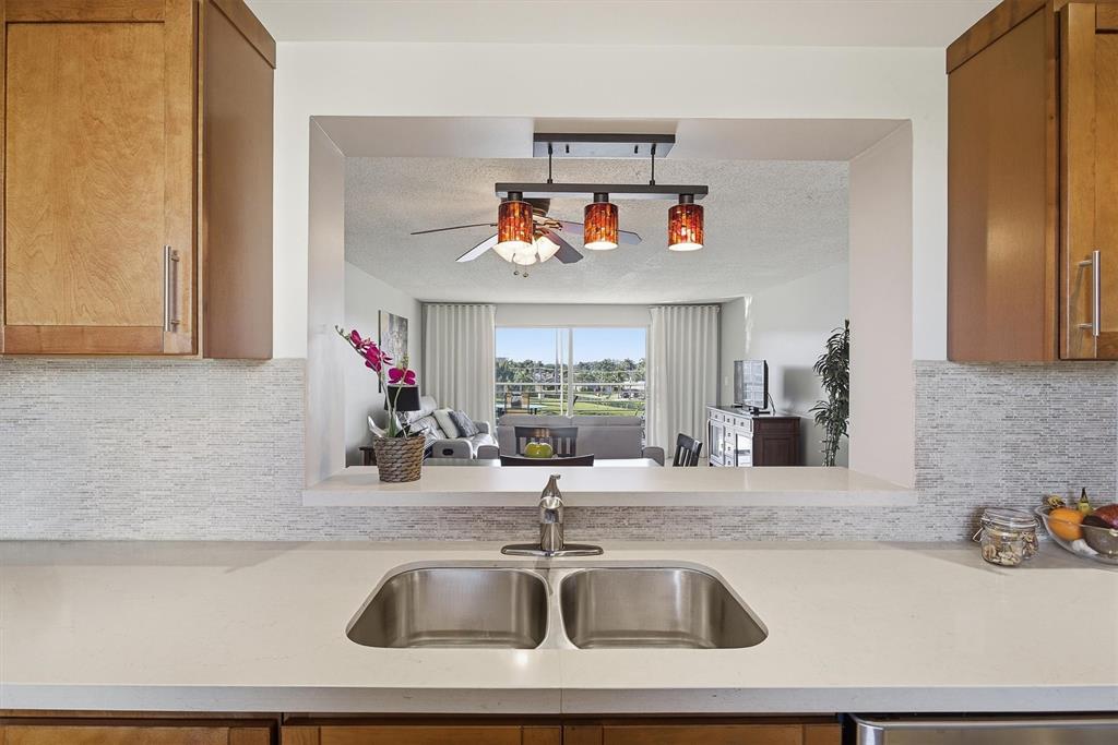 311 Southeast 3rd Street, Unit 410 Dania Beach, FL 33004 - Photo 6 of 51 a kitchen with sink and a refrigerator