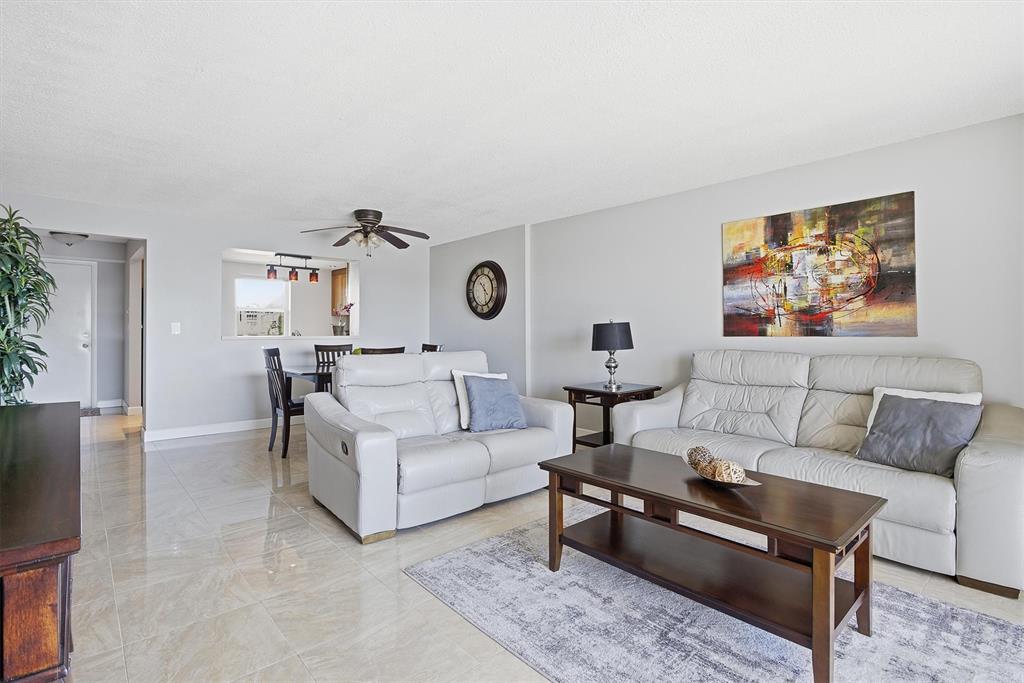 311 Southeast 3rd Street, Unit 410 Dania Beach, FL 33004 - Photo 8 of 51 a living room with furniture and wooden floor