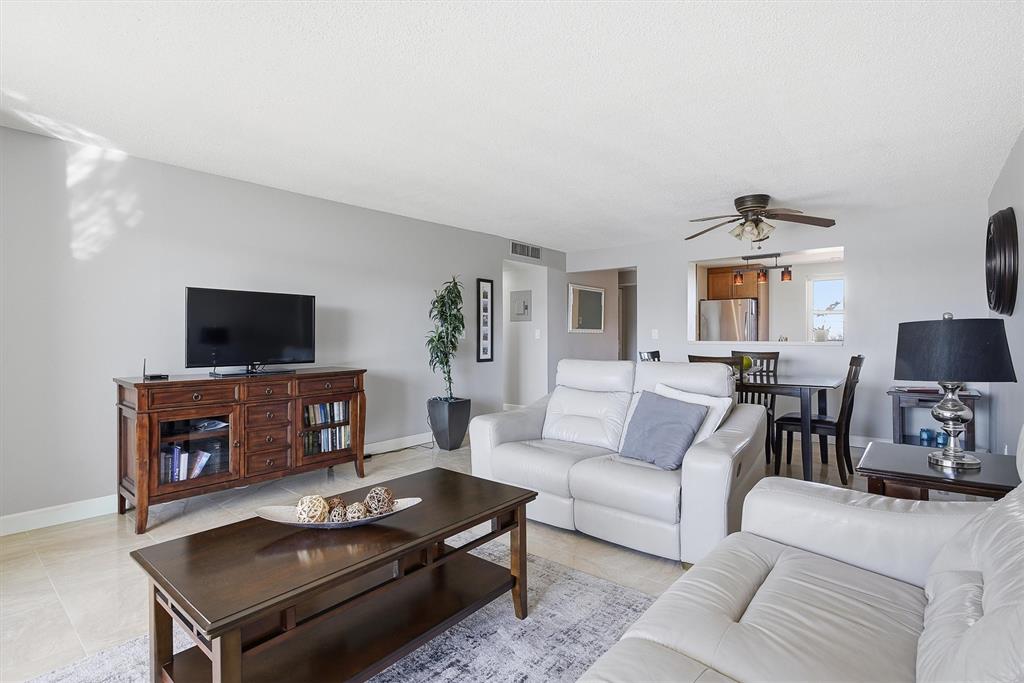 311 Southeast 3rd Street, Unit 410 Dania Beach, FL 33004 - Photo 9 of 51 a living room with furniture a flat screen tv and a fireplace