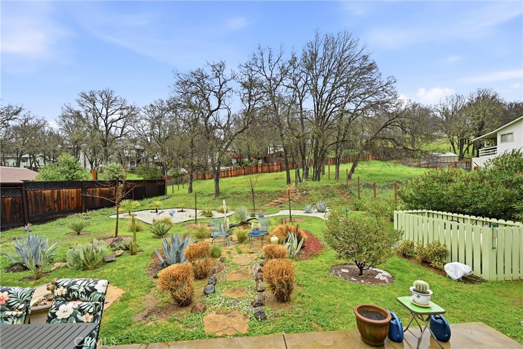 19072 Hidden Valley Road Hidden Valley Lake, CA 95467 - Photo 18 of 27 a backyard of a house with lots of green space and fountain