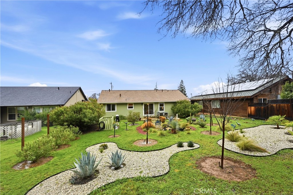 19072 Hidden Valley Road Hidden Valley Lake, CA 95467 - Photo 22 of 27 a view of a patio with table and chairs under an umbrella