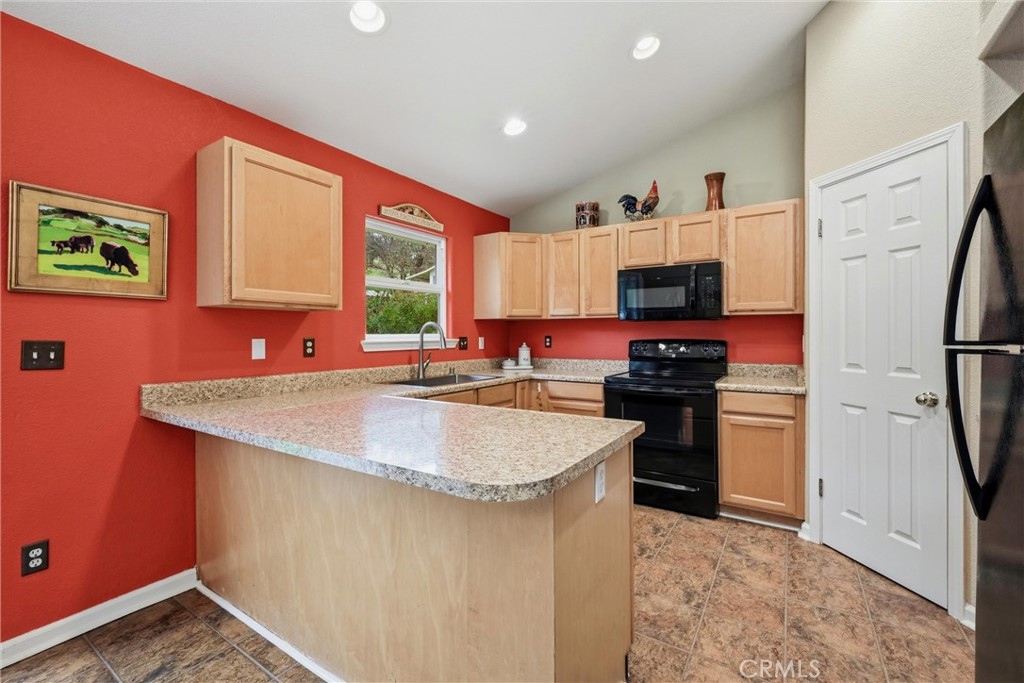 19072 Hidden Valley Road Hidden Valley Lake, CA 95467 - Photo 8 of 27 a kitchen with stainless steel appliances granite countertop a sink stove refrigerator and a window