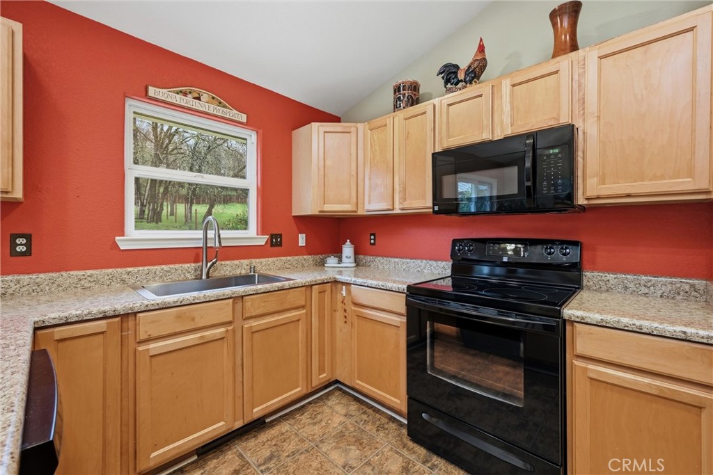 19072 Hidden Valley Road Hidden Valley Lake, CA 95467 - Photo 9 of 27 a kitchen with granite countertop a stove top oven sink and window
