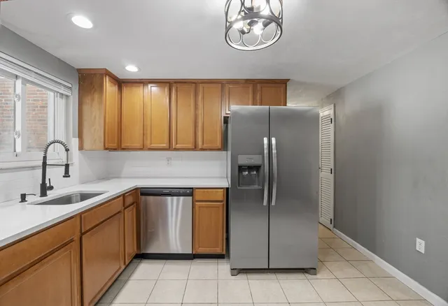 a kitchen with stainless steel appliances granite countertop a refrigerator and a sink