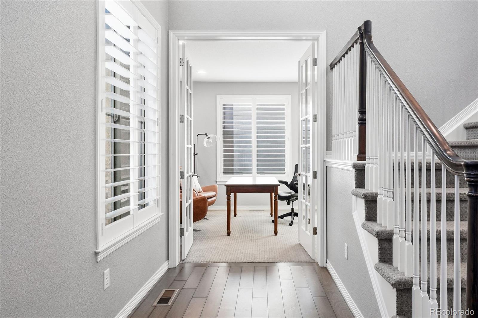 769 Winding Pine Lane Highlands Ranch, CO 80126 - Photo 17 of 50 a view of a hallway with wooden floor and staircase