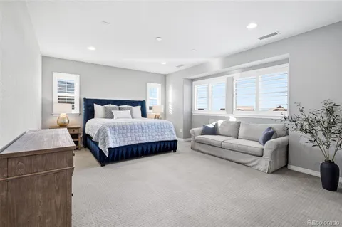 a spacious bedroom with a large bed and a dresser