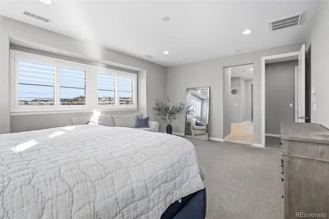 a en suite bathroom with a granite countertop sink and a mirror