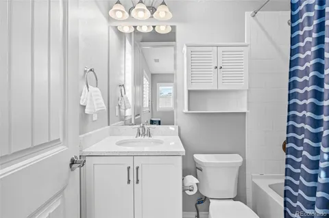 a bedroom with a bed table and a window