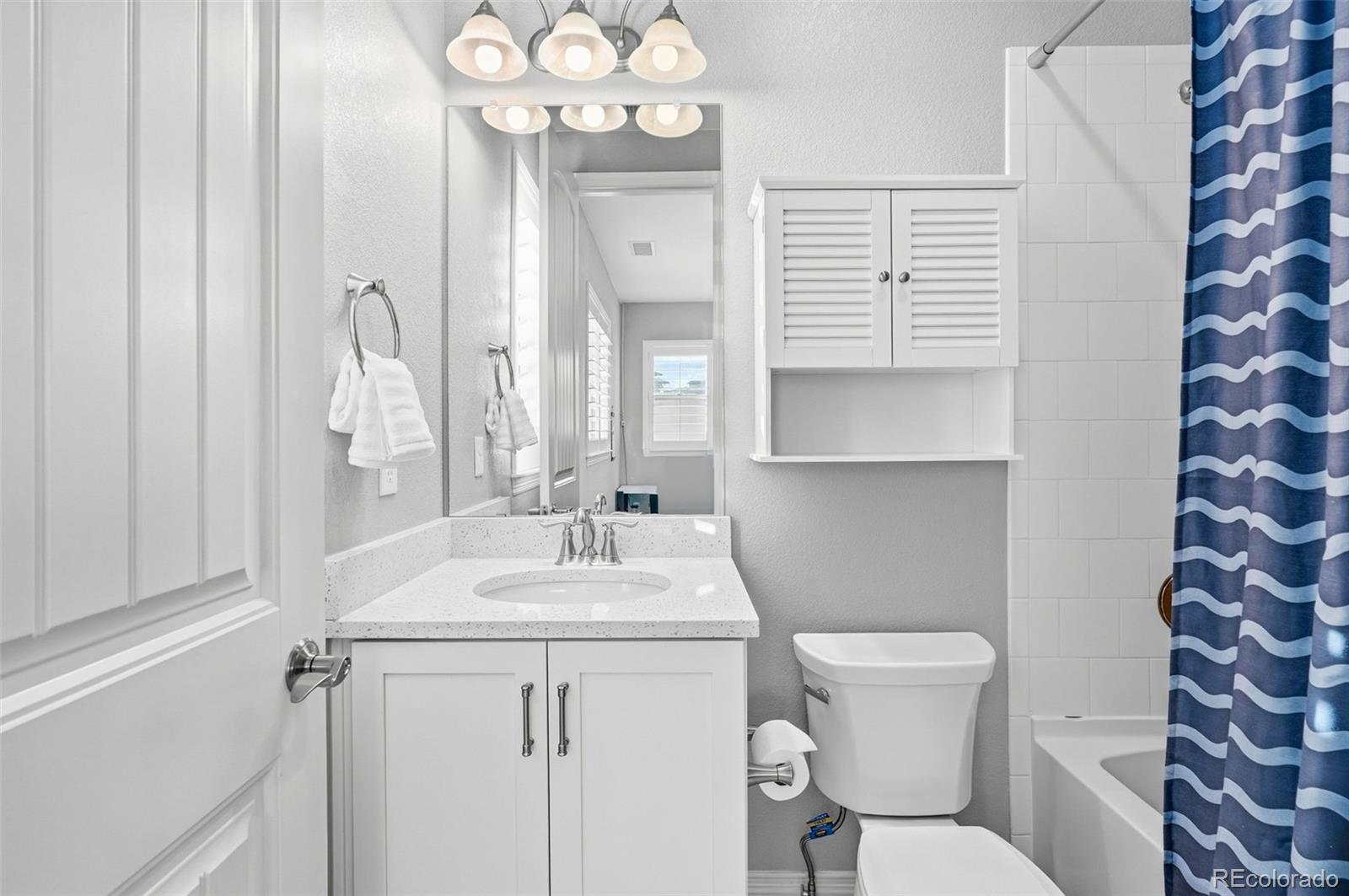 769 Winding Pine Lane Highlands Ranch, CO 80126 - Photo 33 of 50 a bathroom with a sink a toilet and a mirror