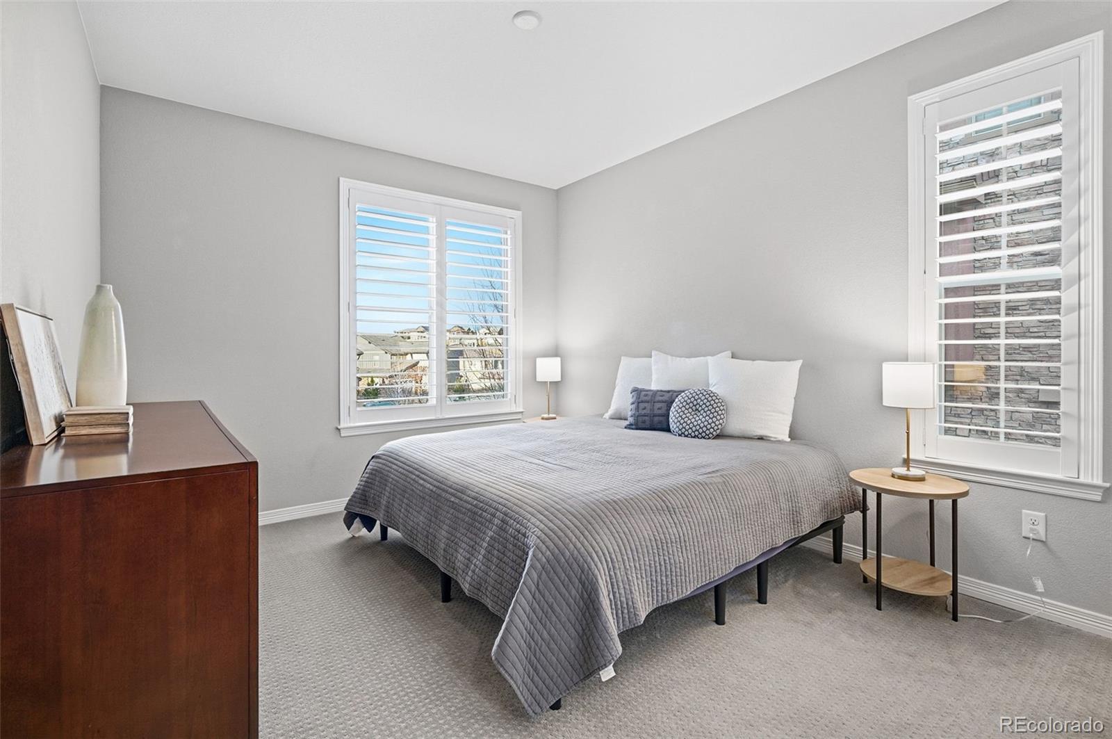 769 Winding Pine Lane Highlands Ranch, CO 80126 - Photo 34 of 50 a bedroom with a bed table and a window