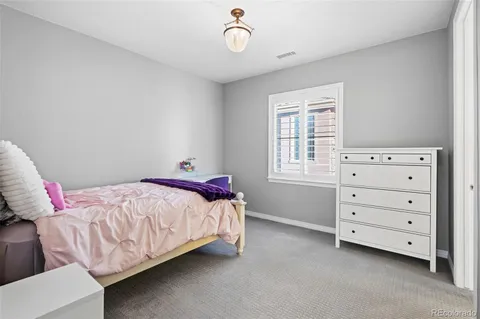 a bedroom with a bed and a desk