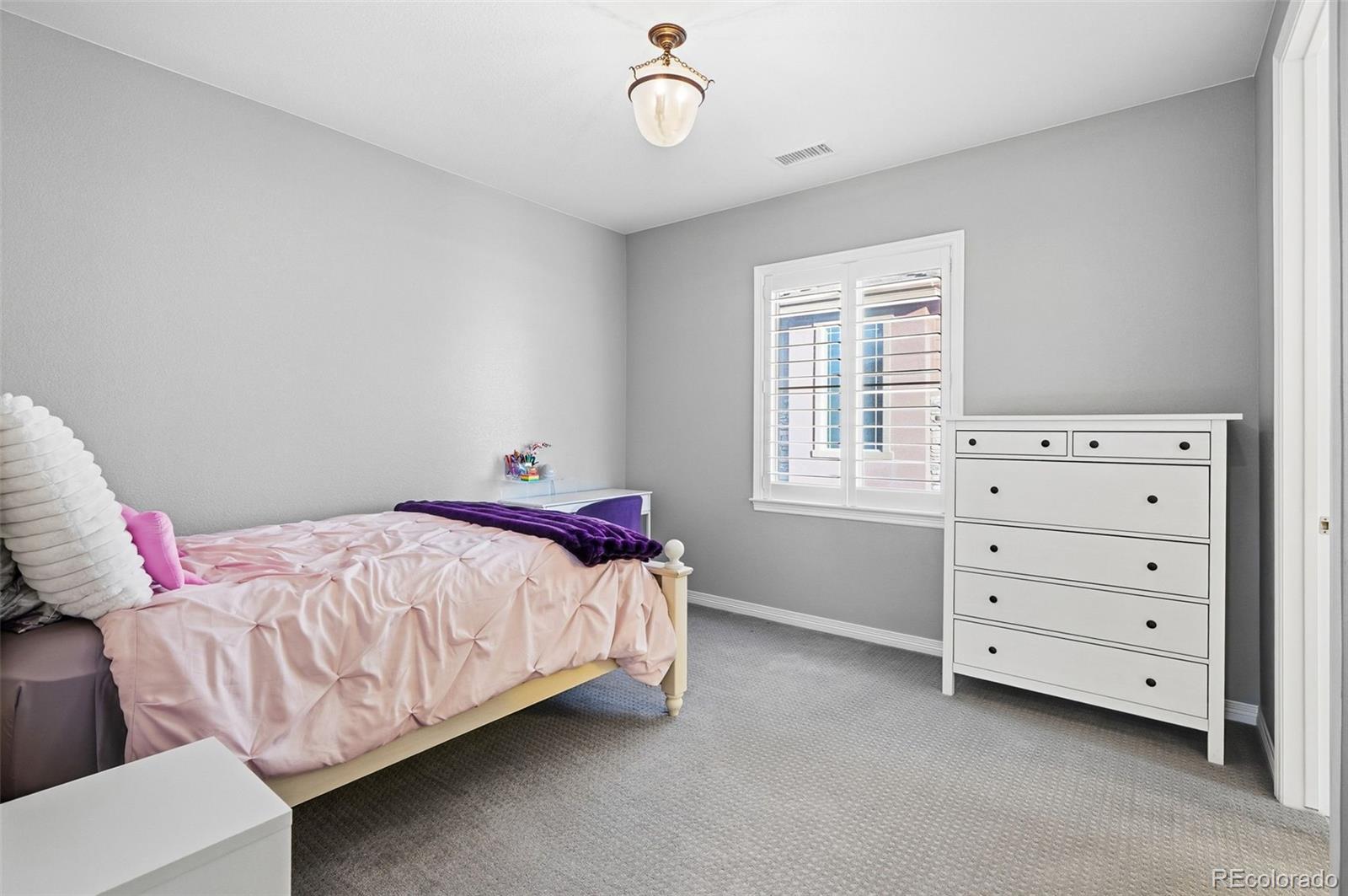 769 Winding Pine Lane Highlands Ranch, CO 80126 - Photo 36 of 50 a bedroom with a bed and a window