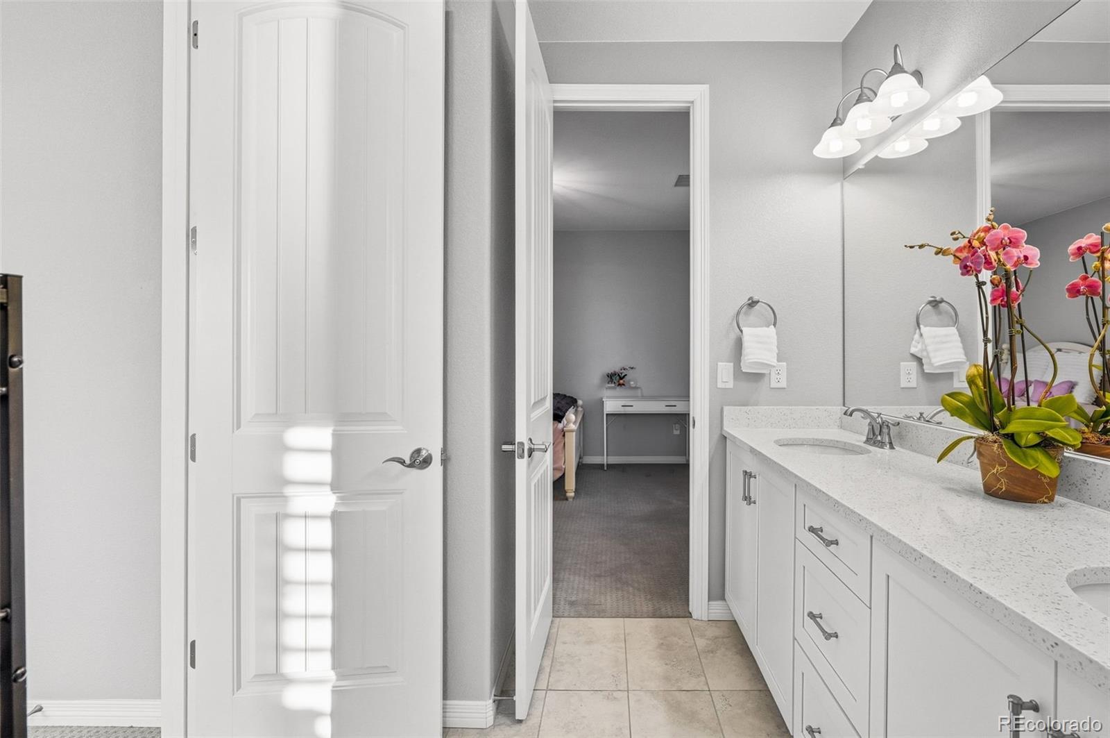 769 Winding Pine Lane Highlands Ranch, CO 80126 - Photo 38 of 50 a bathroom with a double vanity sink and a mirror