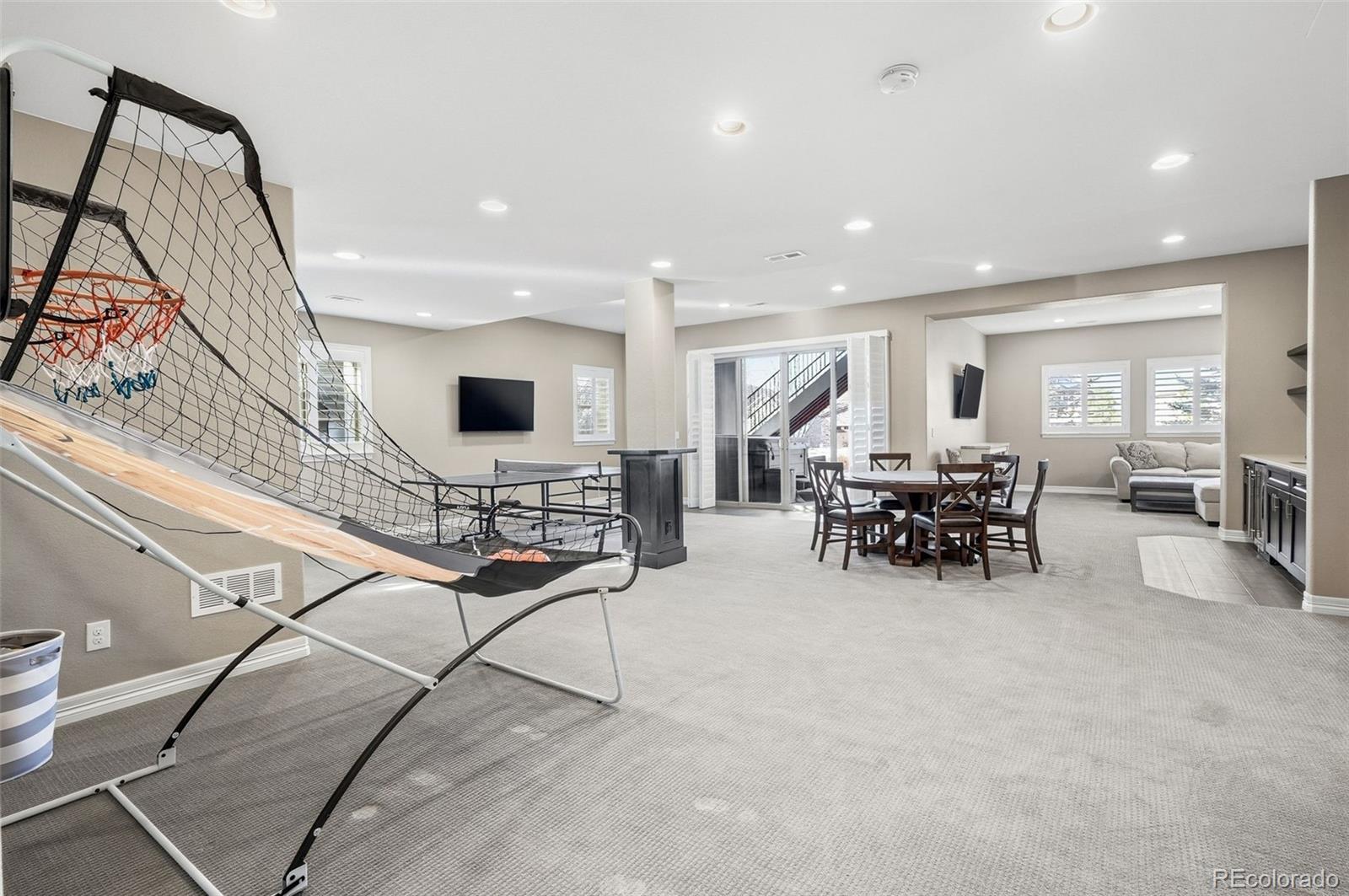 769 Winding Pine Lane Highlands Ranch, CO 80126 - Photo 39 of 50 a view of a livingroom with furniture and a flat screen tv