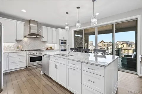 a large kitchen with stainless steel appliances kitchen island granite countertop a large island in the center