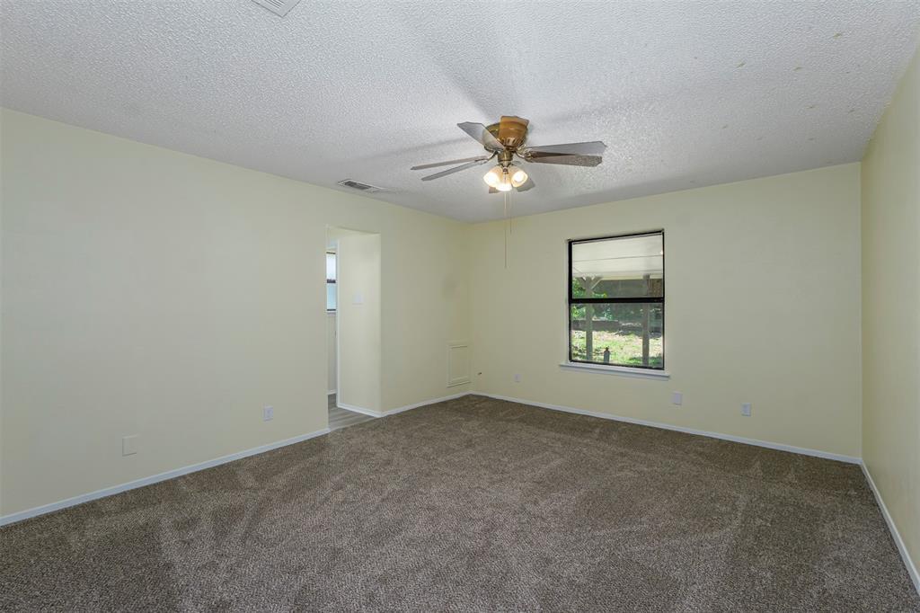 617 Rolling Ridge Court Azle, TX 76020 - Photo 13 of 20 Carpeted room featuring a ceiling fan with integrated lighting, a window with blinds, and light-toned wall finishes
