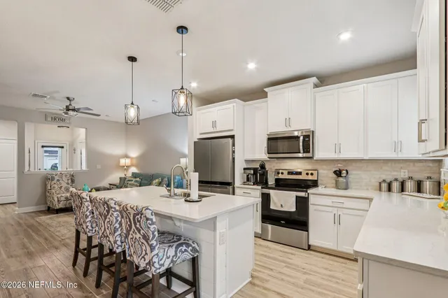a bathroom with a sink vanity mirror and toilet