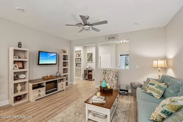 a aerial view of a house with a big yard and large tree