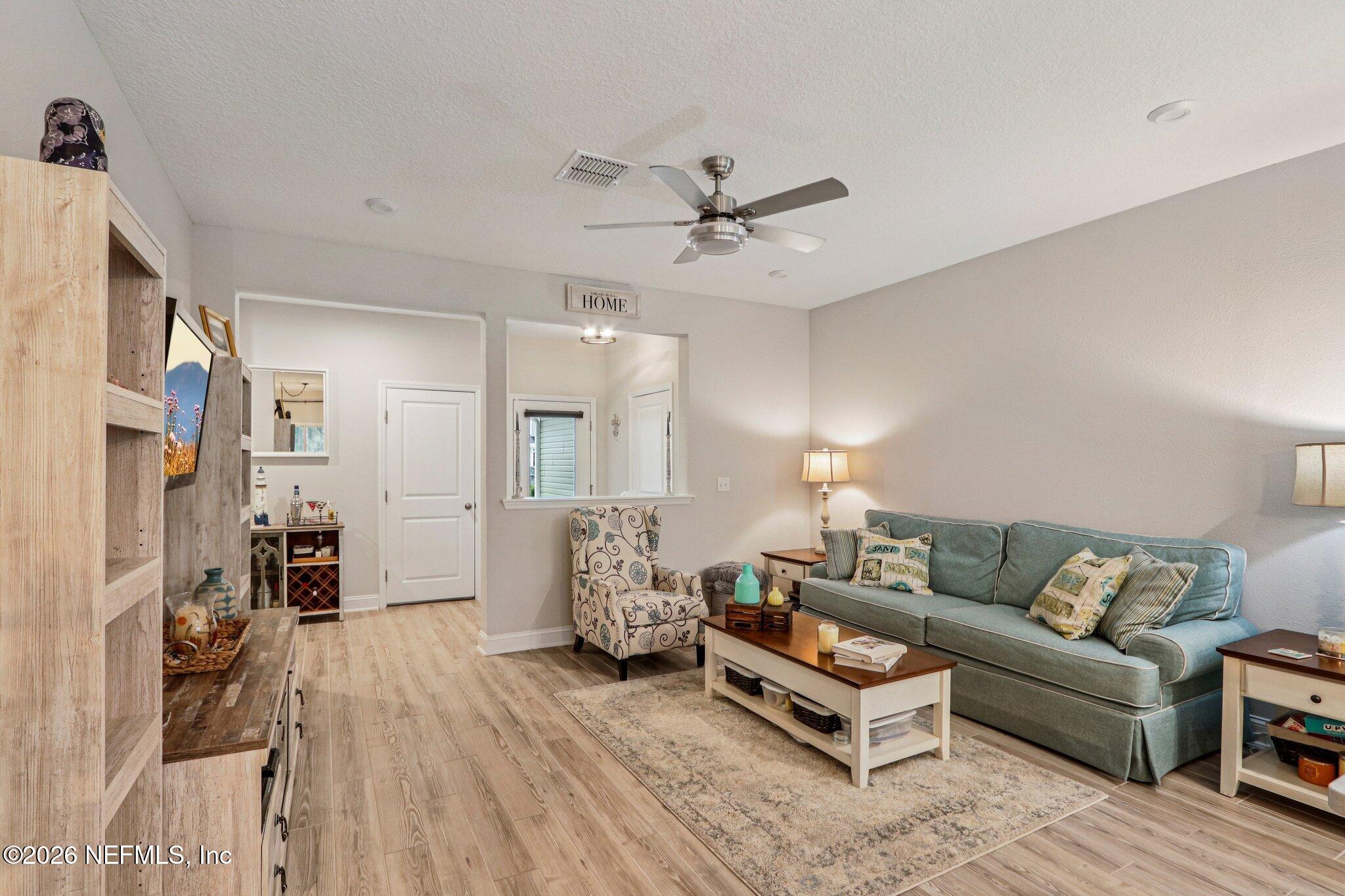 12068 Calvesta Street Jacksonville, FL 32256 - Photo 23 of 100 a living room with furniture and a wooden floor