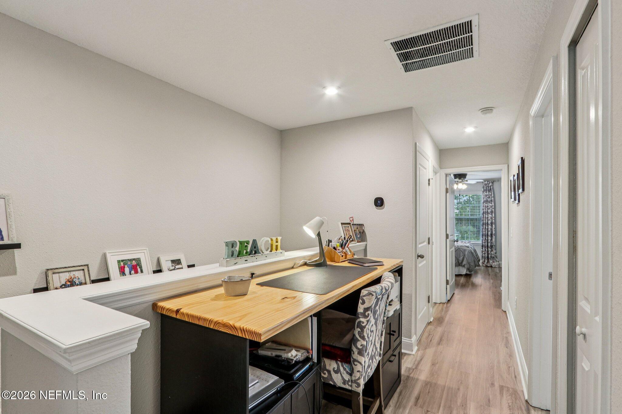 12068 Calvesta Street Jacksonville, FL 32256 - Photo 25 of 100 a view of a kitchen area with furniture and wooden floor