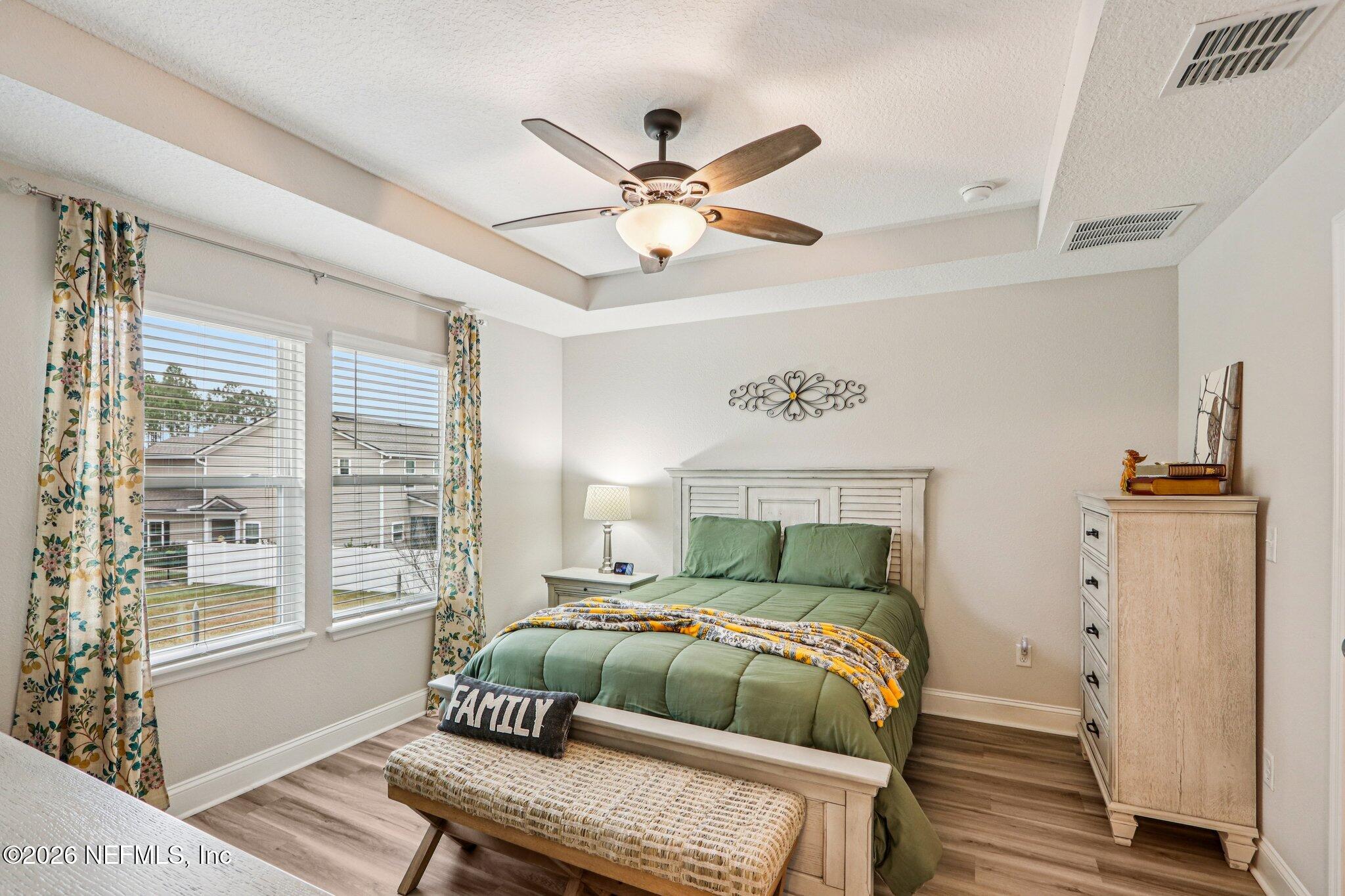 12068 Calvesta Street Jacksonville, FL 32256 - Photo 26 of 100 a bedroom with a bed and wooden floor