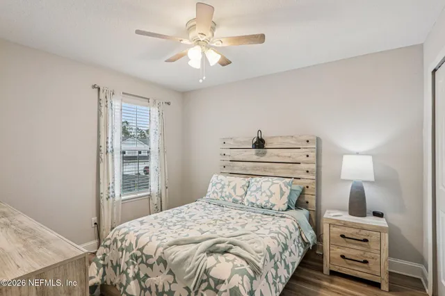 a view of a swimming pool with a lawn chairs under an umbrella