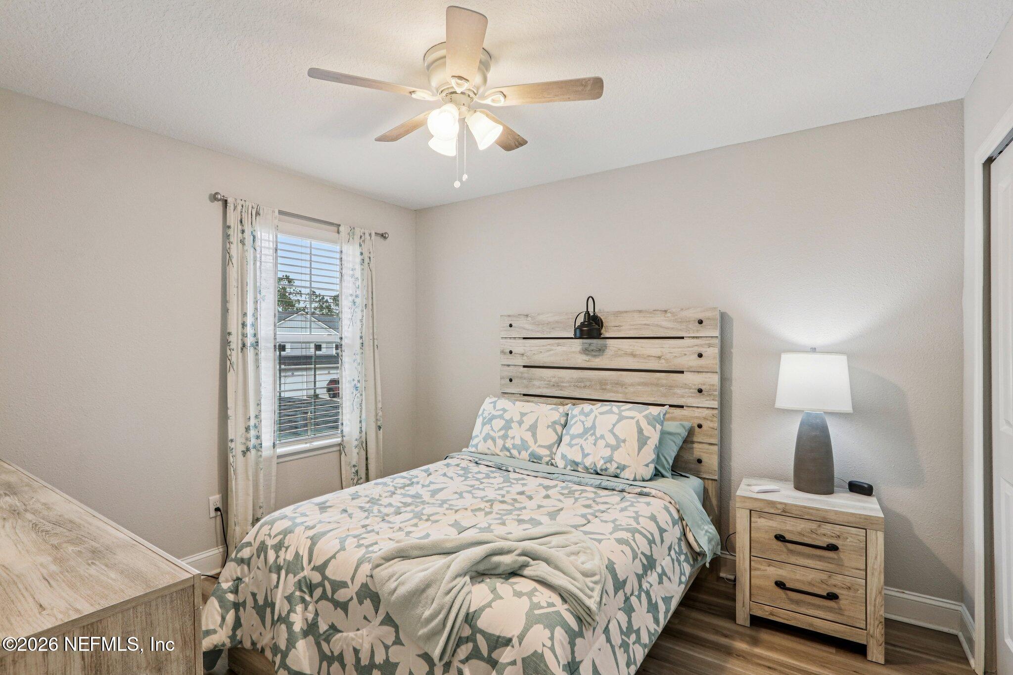 12068 Calvesta Street Jacksonville, FL 32256 - Photo 32 of 100 a bedroom with a bed and a chandelier